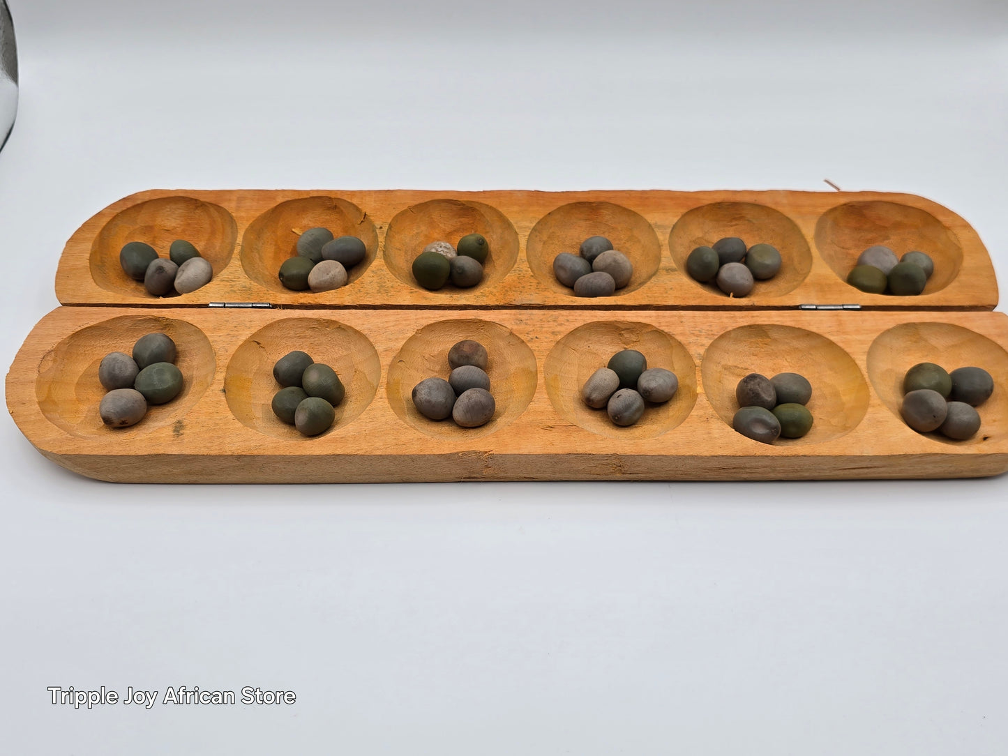 Ayo olopon( Hand carved wooden board game ) with seeds