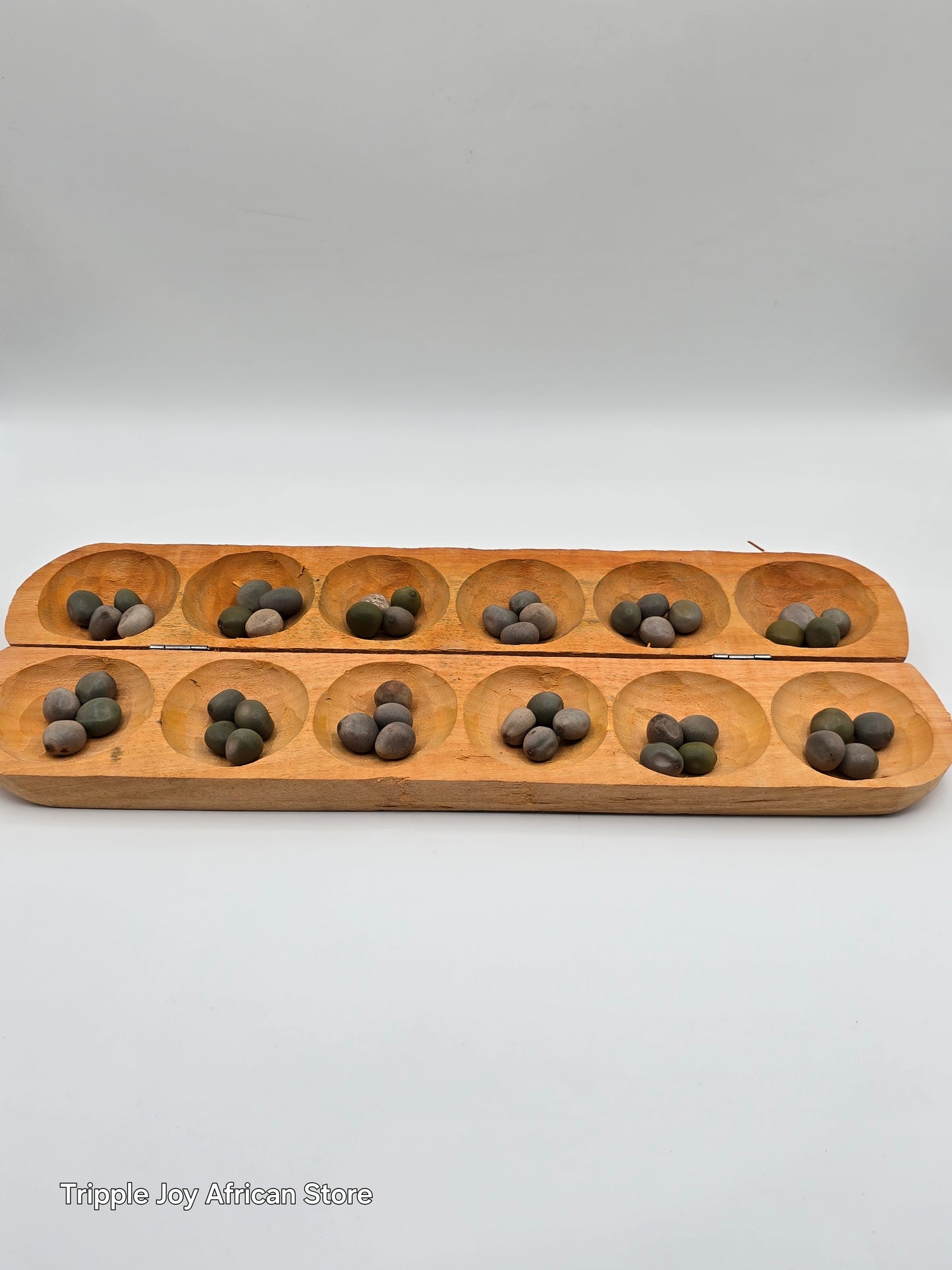 Ayo olopon( Hand carved wooden board game ) with seeds